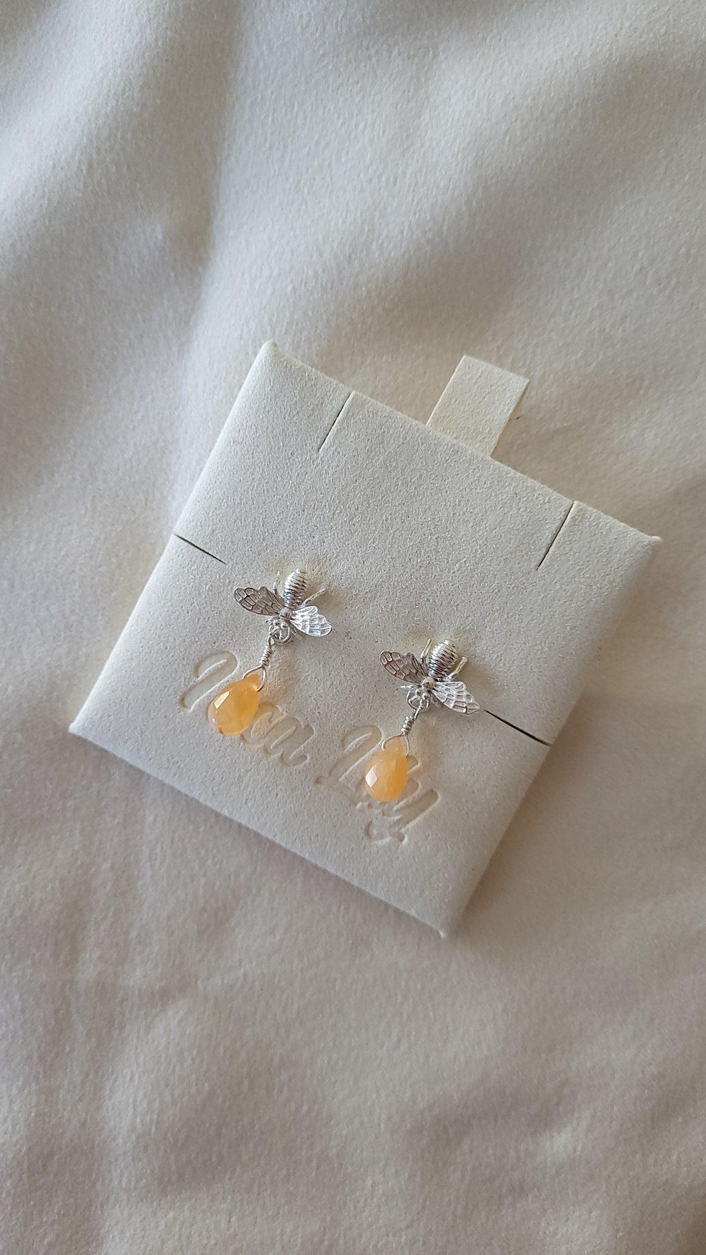 sterling silver honey bee stud earrings with a carnelian briolette cut gemstone